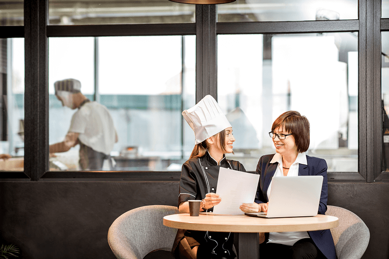 Senior chef and young cook at the restaurant